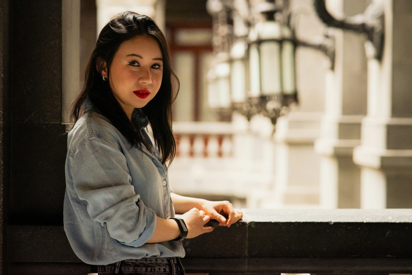 a woman leaning against a wall with her hands on her hips